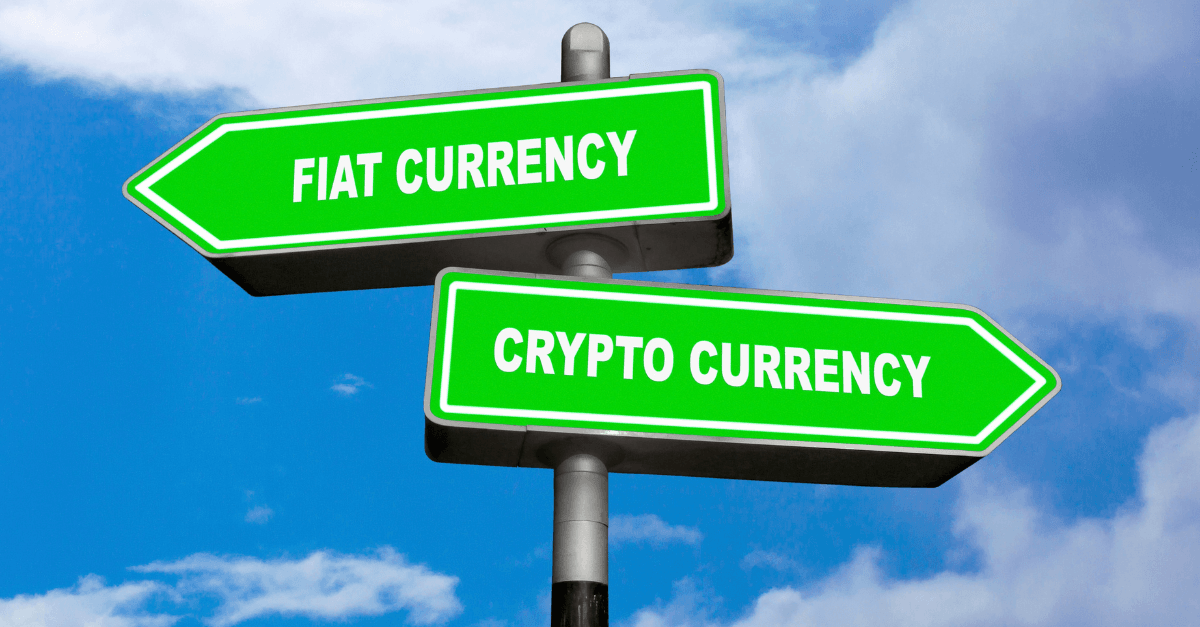 A signpost with arrows pointing to fiat currency and cryptocurrency against a blue sky