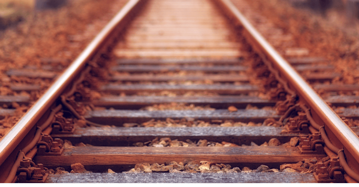  a close view along a railway track, sleepers and rails receding into the distance